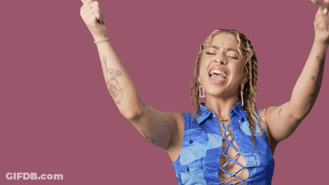 A Woman With Her Arms In The Air With Yas Queen Written On The Bottom GIF