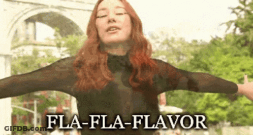 Woman With Arms Outstretched And Fla-Fla-Flavor Text GIF