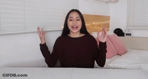 A Woman With Her Arms Outstretched And The Words I 'M Back GIF