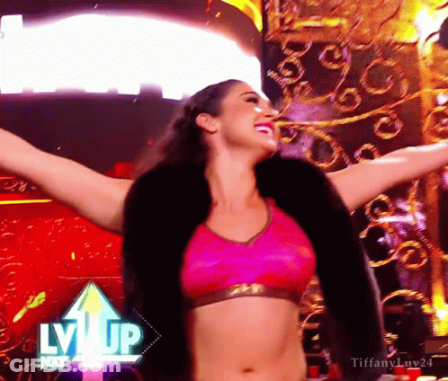 A Woman With Her Arms Outstretched In Front Of A Sign That Says Lvvip GIF