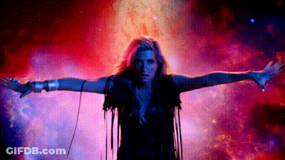 A Woman With Her Arms Outstretched Is Standing In Front Of A Galaxy . GIF