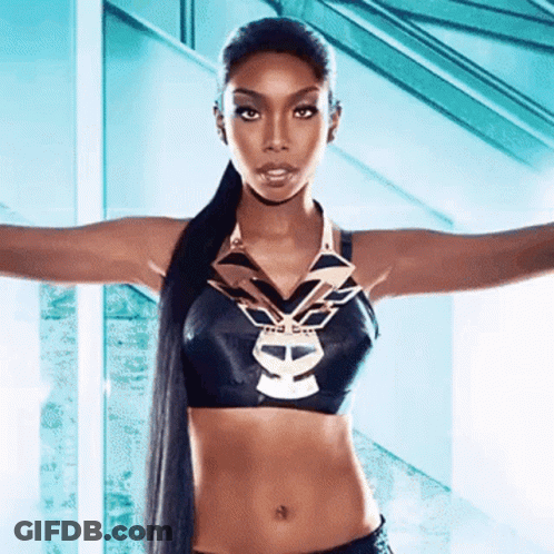 Woman In Black Crop Top With Skull And Necklace GIF
