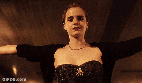 A Woman With Her Arms Outstretched Wearing A Black Top GIF