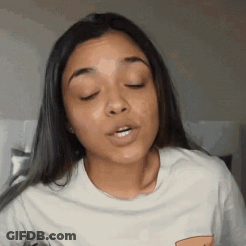 A Woman With Her Eyes Closed And Her Mouth Open GIF