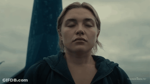 A Woman With Her Eyes Closed And The Word Thunderbolts On The Bottom Right GIF