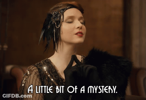 A Woman With Her Eyes Closed And The Words A Little Bit Of A Mystery GIF