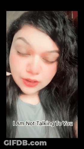 A Woman With Her Eyes Closed And The Words I Am Not Talking To You Above Her GIF