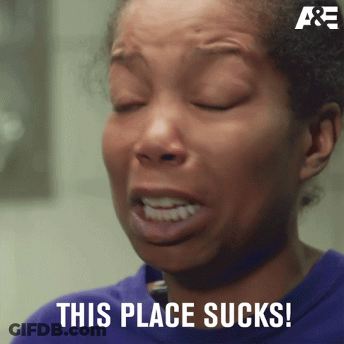 A Woman With Her Eyes Closed And The Words This Place Sucks On The Bottom GIF