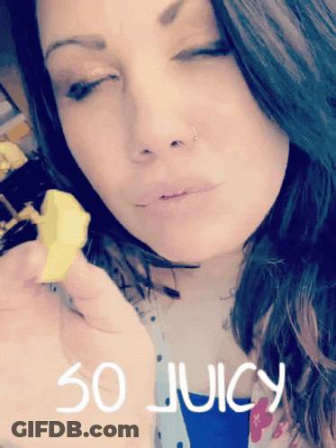 A Woman With Her Eyes Closed Is Holding A Piece Of Food With The Words So Juicy Written On The Bottom GIF