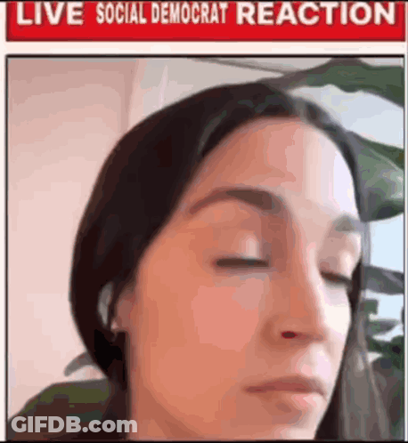 A Woman With Her Eyes Closed Is In Front Of A Sign That Says Live Social Democrat Reaction . GIF
