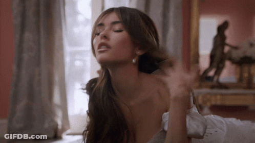 A Woman With Her Eyes Closed Is Laying On Her Back GIF