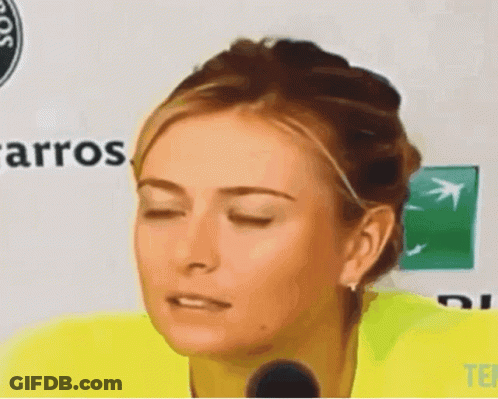 A Woman With Her Eyes Closed Is Standing In Front Of A Sign That Says Carros GIF