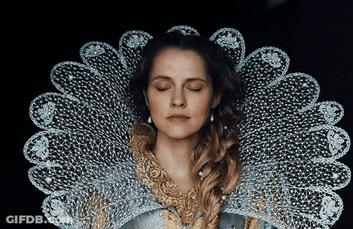 A Woman With Her Eyes Closed Is Wearing A Lace Collar Around Her Neck GIF