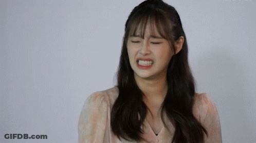 A Woman With Her Eyes Closed Making A Funny Face GIF