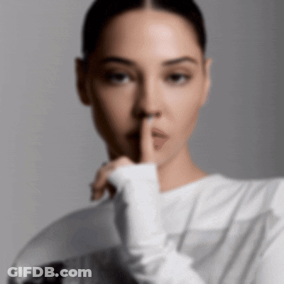 A Woman With Her Finger To Her Mouth GIF