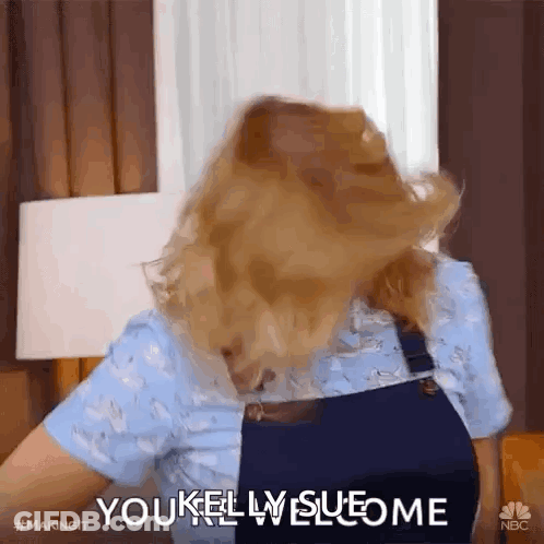 A Woman With Her Hair Blowing In The Wind Is Saying You Kelly Sueome GIF