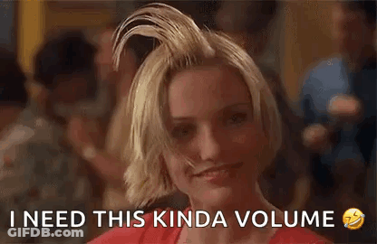 A Woman With Her Hair In A Bun Is Smiling And Says `` I Need This Kinda Volume '' . GIF