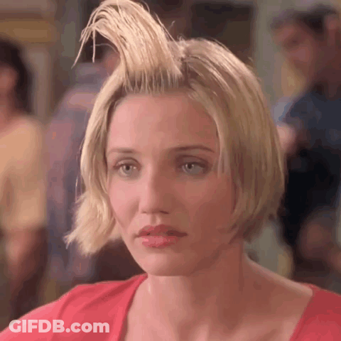A Woman With Her Hair In A Mohawk And A Red Shirt . GIF