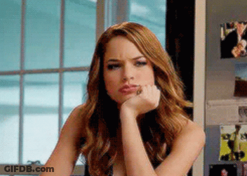 A Woman With Her Hand On Her Chin Is Sitting In Front Of A Window . GIF