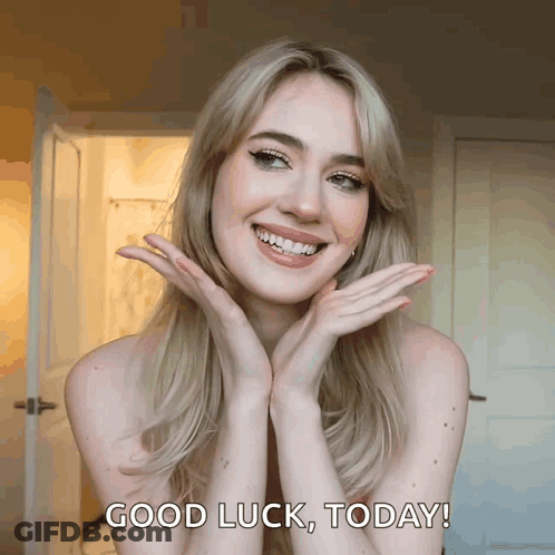 A Woman With Her Hands On Her Face Is Smiling And Says " Good Luck Today " GIF