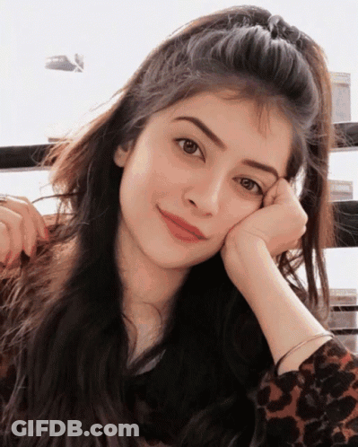 A Woman With Her Head Resting On Her Hand GIF