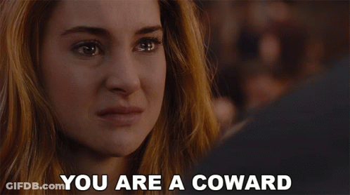A Woman With Her Mouth Open And The Words " You Are A Coward " Behind Her GIF