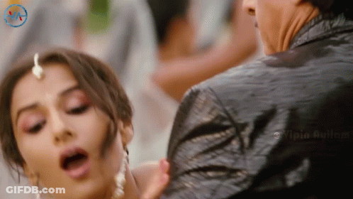 A Woman With Her Mouth Open Is Being Held By A Man In A Black Jacket With A Watermark That Says Vipia Aulum GIF