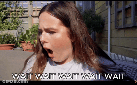 A Woman With Her Mouth Wide Open And The Words Wait Wait Wait Wait GIF