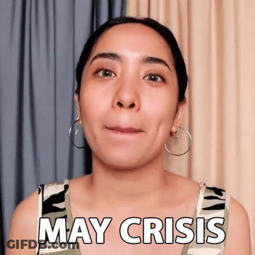 A Woman With Hoop Earrings Is Making A Funny Face And Saying May Crisis . GIF