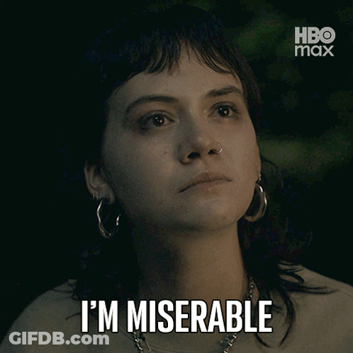 A Woman With Hoop Earrings Says I 'M Miserable In Front Of A Hbo Max Logo GIF