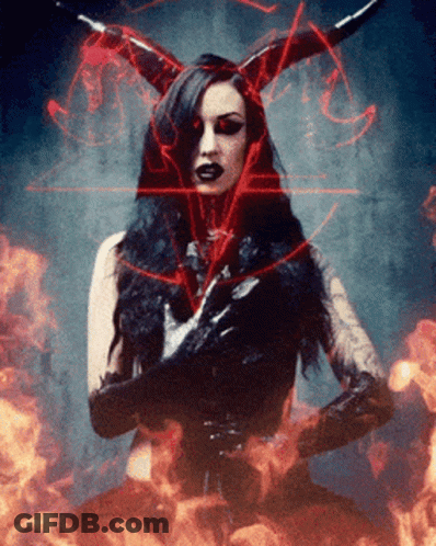 A Woman With Horns And Gloves Is Surrounded By Fire GIF