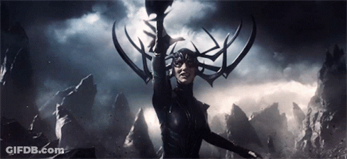 A Woman With Horns On Her Head Is Holding A Sword In The Dark . GIF