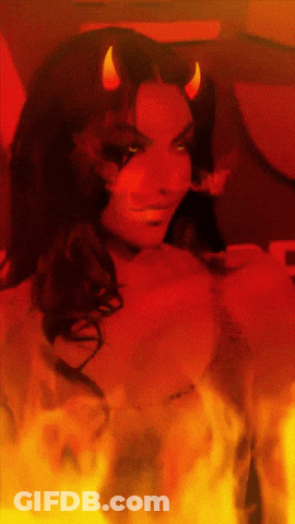 A Woman With Horns On Her Head Is Surrounded By Fire And Smoke GIF