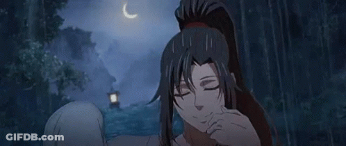A Woman With Long Black Hair And A Ponytail Is Standing In A Forest . GIF