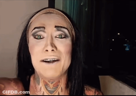 A Woman With Long Black Hair And Green Eyes Is Wearing A Headband And Making A Funny Face . GIF
