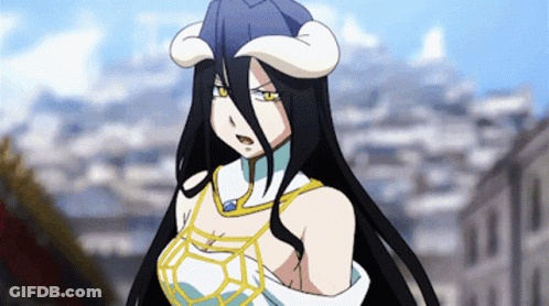 A Woman With Long Black Hair And Horns Is Standing In Front Of Buildings GIF