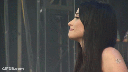 A Woman With Long Black Hair Has A Tattoo On Her Shoulder That Says ' A ' On It GIF
