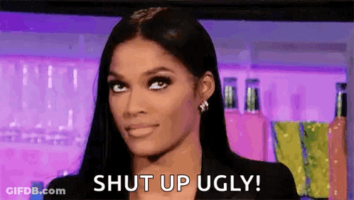 A Woman With Long Black Hair Is Making A Funny Face And Says `` Shut Up Ugly '' . GIF
