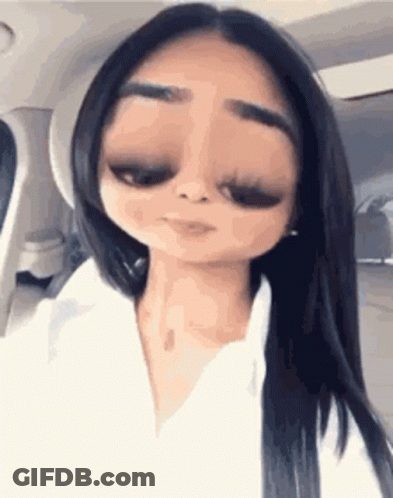 A Woman With Long Black Hair Is Sitting In A Car With A Cartoon Face . GIF