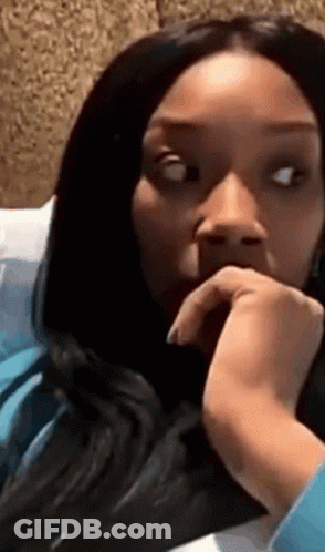 Woman With Long Black Hair Sitting On Bed GIF
