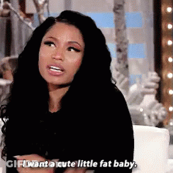 A Woman With Long Black Hair Is Sitting On A Couch And Talking . GIF
