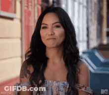 Woman With Long Black Hair In Front Of Building GIF