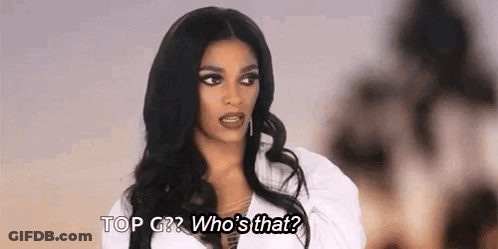 A Woman With Long Black Hair Is Talking To Another Woman While Wearing A White Shirt . GIF