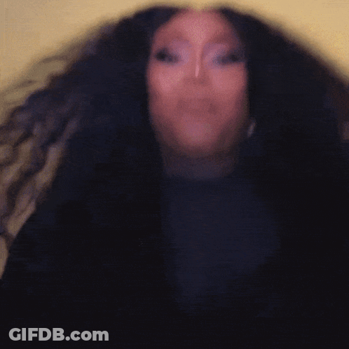 A Woman With Long Black Hair Is Wearing A Black Shirt GIF
