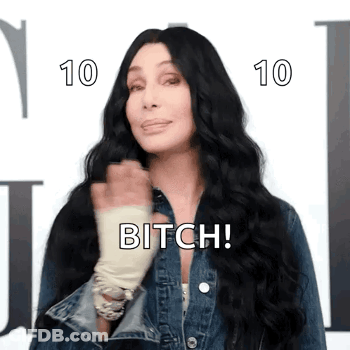 A Woman With Long Black Hair Is Wearing A Denim Jacket And Says Bitch ! GIF