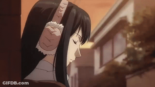 A Woman With Long Black Hair Is Wearing Ear Protectors GIF