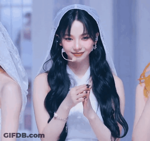 A Woman With Long Black Hair Wearing A White Dress And Veil . GIF