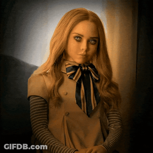 A Woman With Long Blonde Hair And A Bow Tie GIF