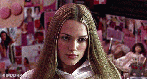 A Woman With Long Blonde Hair And A White Shirt GIF