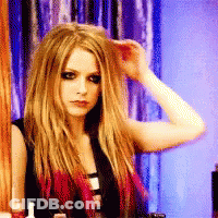 A Woman With Long Blonde Hair Holds Her Hand To Her Forehead GIF